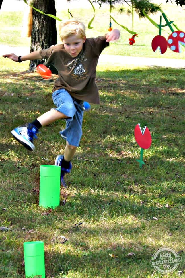 boy jumping in obstacle course