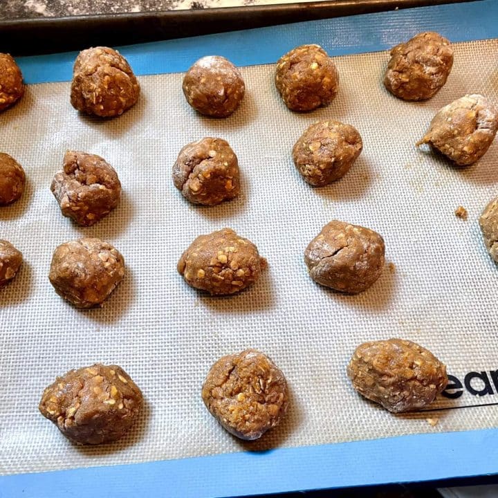 A baking sheet full of raw cookie dough.